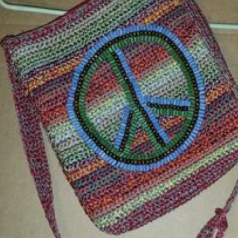The sak peace sign crossbody crochet bag